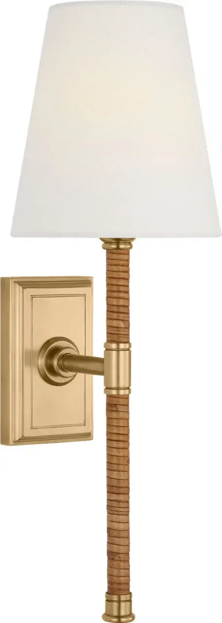 The Basden 16" Tail Sconce combines natural rattan weaving with antique-burnished brass for a sophisticated coastal aesthetic. The linen shade softens light beautifully while the extended tail design adds architectural interest.