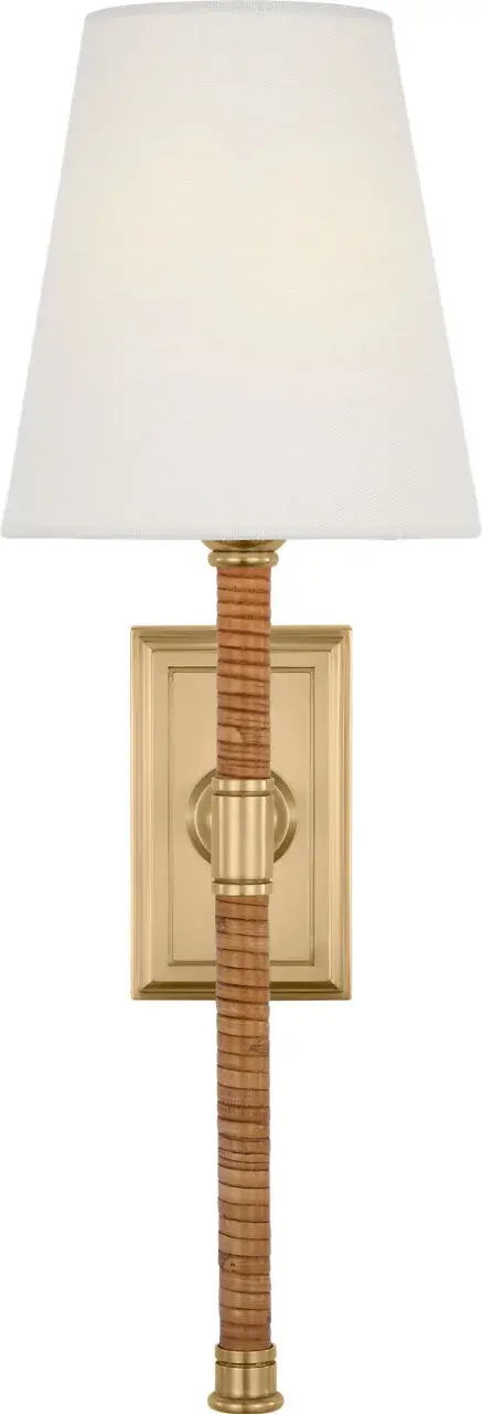 The Basden 16" Tail Sconce combines natural rattan weaving with antique-burnished brass for a sophisticated coastal aesthetic. The linen shade softens light beautifully while the extended tail design adds architectural interest. - alternate view