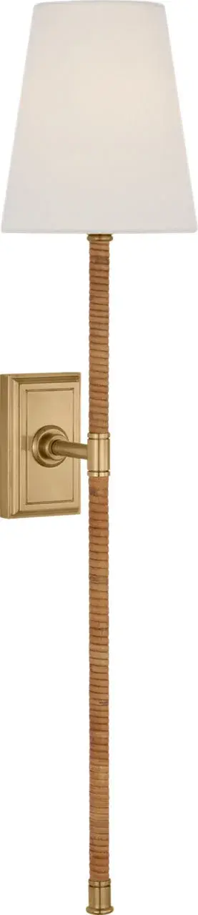 The Basden Tail Sconce combines antique-burnished brass with natural rattan for a refined organic aesthetic. At 29 inches, it makes a statement while maintaining versatility across traditional and contemporary spaces.