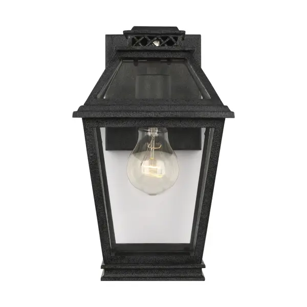 The Falmouth outdoor wall lantern by Chapman & Myers brings timeless charm with its vintage gas lantern-inspired design. The clean-lined tapered box frame in dark weathered zinc showcases clear glass panels beautifully.