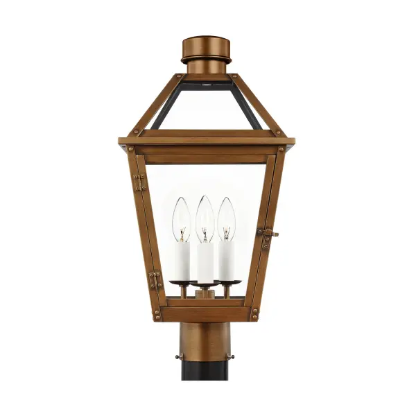 The Hyannis post mount brings timeless lantern styling to outdoor spaces with its natural copper finish and clear glass panels. Rivet details and a spun metal chimney cap add authentic period character.
