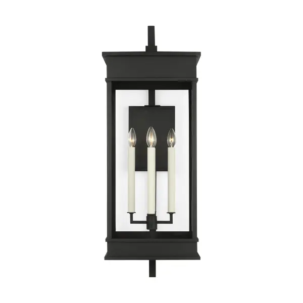 The Cupertino outdoor wall sconce by Chapman & Myers combines transitional design with architectural detailing. Its rectangular lantern profile features stepped top and bottom details, cream candle tubes, and clear glass panels in a durable textured black finish.