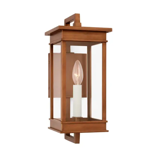 The Cupertino wall lantern by Chapman & Myers brings transitional elegance to outdoor spaces with its rectangular profile and natural copper finish. Features traditional candelabra styling with cream candle tubes and architectural stepped detailing.