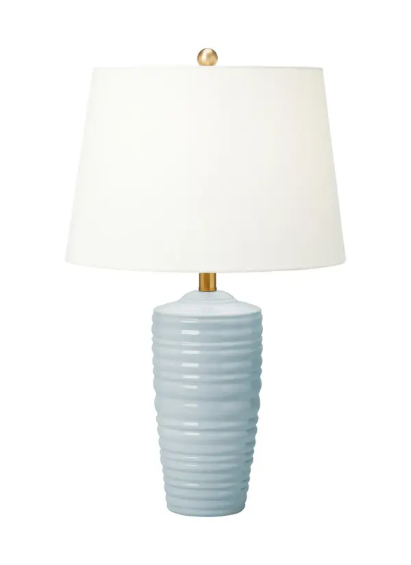 The Waveland table lamp features a tapered ceramic base with subtle curvilinear molding details inspired by classical architecture. Its neutral frosted finish and white linen shade make it adaptable across design styles.