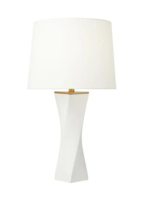 The Lagos table lamp features a striking twisted torsional ceramic base with a white leather finish, complemented by a clear glass accent and crisp white linen shade. Its architectural form makes a bold statement while remaining versatile.
