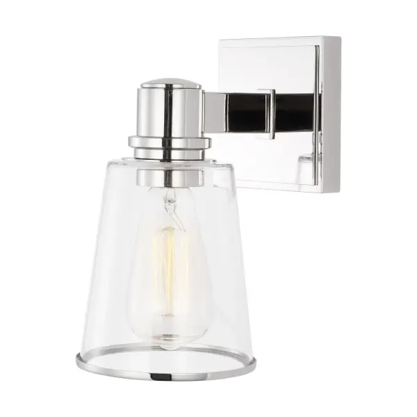 Chapman & Myers' Alessa sconce pairs polished nickel with tapered clear glass for a refined, versatile look. The conical shade frames vintage-style bulbs beautifully while the compact 5-inch width fits tight spaces.