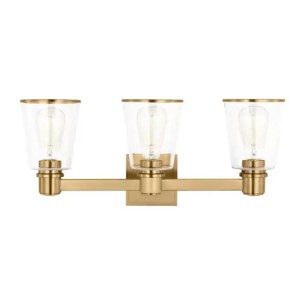 The Alessa vanity light by Chapman & Myers combines simple geometric forms with warm burnished brass for a refined bathroom statement. Clear conical glass shades showcase vintage-style bulbs while rectangular metal arms provide architectural interest.