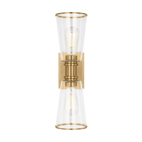 The Alessa vanity light combines simple geometric forms with quality materials. Burnished brass arms support tapered clear glass shades that showcase vintage-style bulbs. Compact at 18 inches tall, it works in tight spaces.