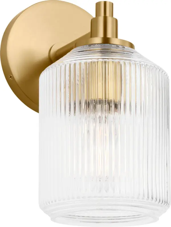 The Barstow 9" vanity light combines vintage prismatic glass craftsmanship with modern minimalism. Its ribbed clear shade and refined metal frame deliver architectural sophistication in a compact form, perfect for smaller vanities or paired installations.