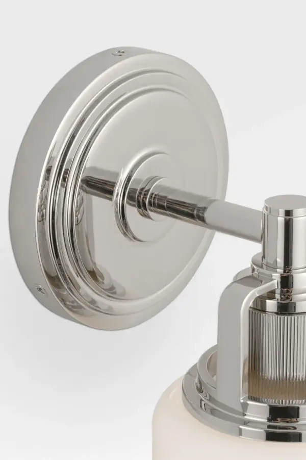 The Ashford 11" brings sophisticated industrial detailing to smaller bath spaces with its square arch bracket, circular collar, and vertically knurled socket cover. White cylindrical glass provides clean illumination while the open collar design allows upward light distribution. - alternate view