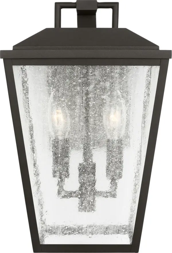The Kennewick Medium Wall Lantern combines traditional lantern styling with a contemporary textured black finish. Its clear glass panels provide excellent illumination while the durable construction ensures long-lasting outdoor performance. - alternate view