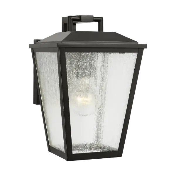 The Kennewick Small Wall Lantern delivers traditional charm in a compact footprint. Its antique bronze finish and clear glass panels create welcoming illumination for entryways, porches, and smaller outdoor spaces.