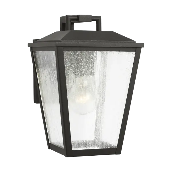 The Kennewick Small Wall Lantern delivers traditional outdoor lighting charm in a compact footprint. Its textured black finish and clear glass panels create welcoming illumination for entryways, porches, and patios.