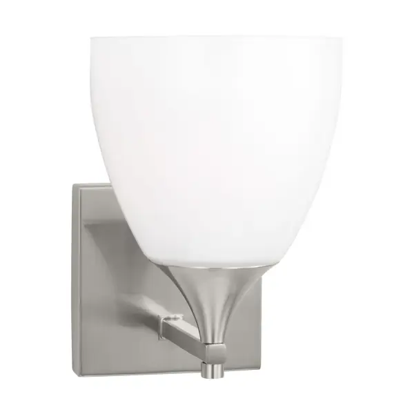 The Toffino Wall Sconce blends traditional form with contemporary finishes, featuring a milk glass shade and brushed steel construction. Its reversible mounting and damp location rating make it ideal for bathrooms and hallways.