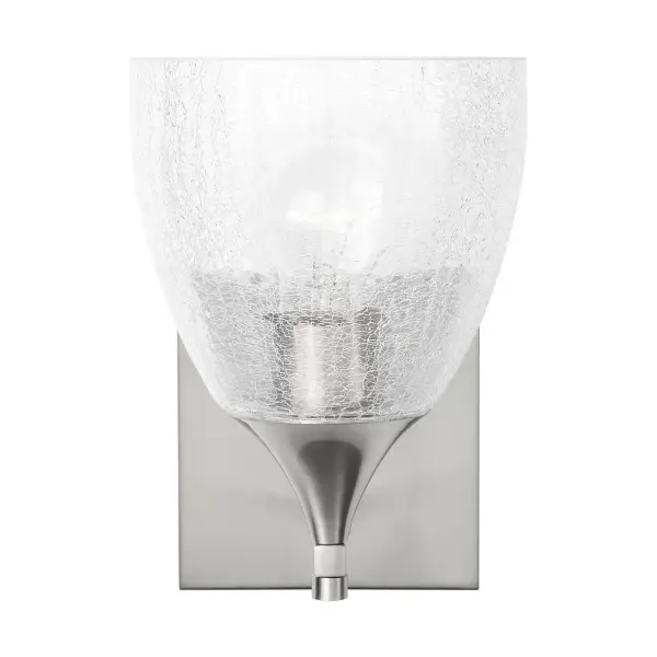 The Toffino wall sconce blends traditional form with contemporary finishes and textured crackle glass. Its compact 6-inch width and reversible mounting make it ideal for bathroom vanities and tight spaces.