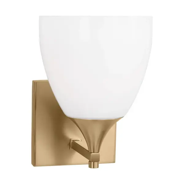 The Toffino Wall Sconce blends traditional form with contemporary finishes, featuring a milk glass shade and satin brass construction. Its reversible mounting and damp location rating make it ideal for bathrooms and hallways.