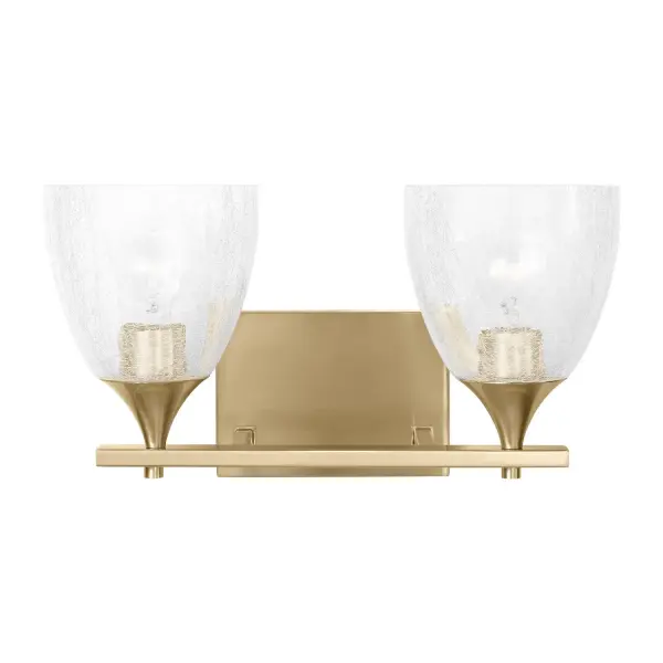 The Toffino vanity light bridges traditional and modern design with its crackle glass shades and clean satin brass finish. Designed by Drew & Jonathan Scott, it offers versatile mounting options and damp location rating for reliable bathroom use.