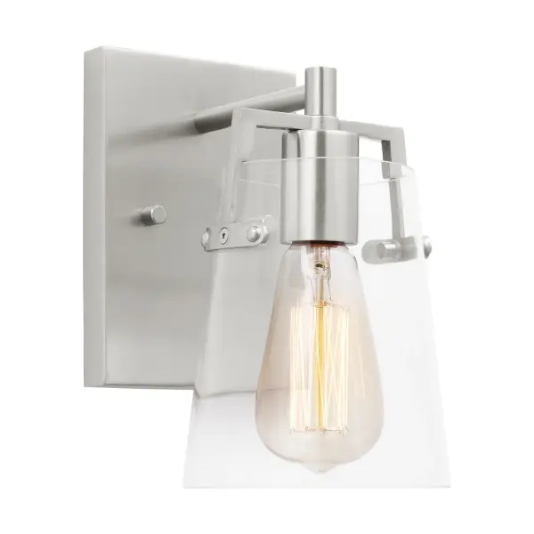 Drew & Jonathan's Crofton sconce delivers clean-lined style with practical flexibility. The clear glass shade showcases filament bulbs beautifully, while the reversible mounting and damp rating make it adaptable to various spaces.