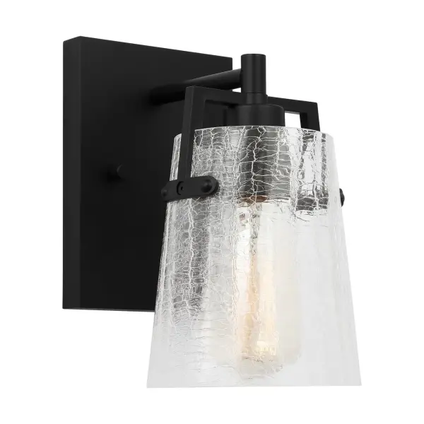 The Crofton wall sconce by Drew & Jonathan Scott combines clean lines with textured crackle glass for a sophisticated look. Its compact 5.25" width and reversible mounting make it ideal for bathrooms and hallways.