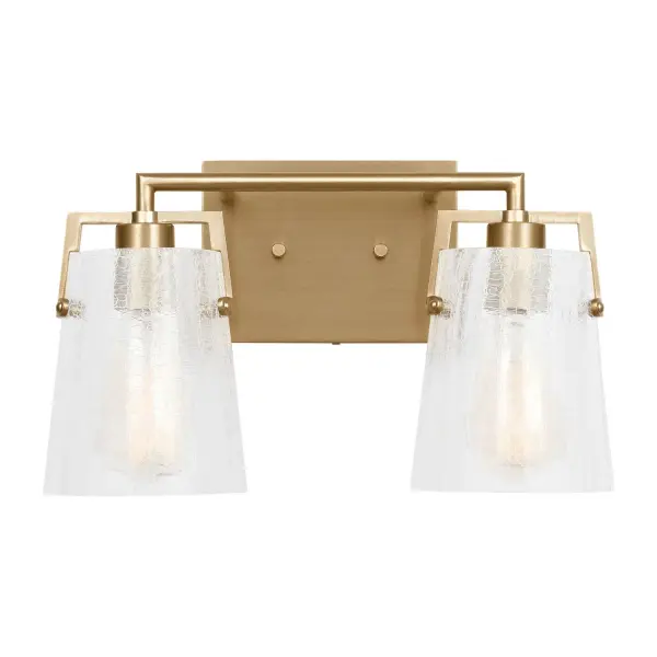 The Crofton vanity light by Drew & Jonathan Scott delivers contemporary style with practical versatility. Its crackle glass shade and satin brass finish create visual interest while the reversible mounting allows customization for any space.
