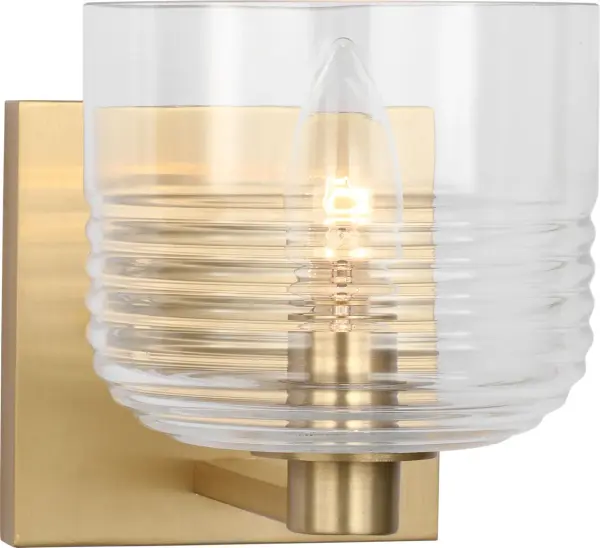 The Lochdale Small Sconce delivers refined lighting in a compact profile. Its satin brass finish adds warmth and sophistication to intimate spaces, making it ideal for powder rooms, hallways, and bedside applications.
