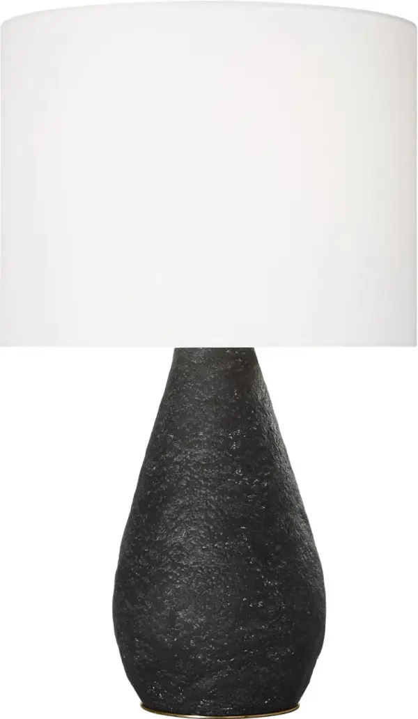 The Breccia Medium Table Lamp combines organic sculptural form with a refined black wash finish. Its ceramic base features natural texture that adds depth and visual interest, while the neutral fabric shade provides warm, diffused light. - alternate view