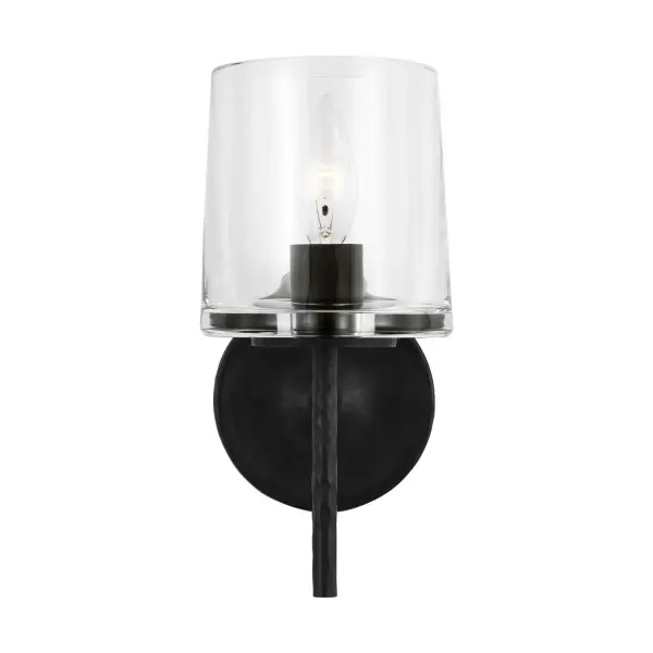 The Marietta wall sconce by Ellen DeGeneres combines industrial authenticity with mid-century sophistication. Its hammered Aged Iron finish and mouth-blown clear glass create visual interest while maintaining a streamlined profile perfect for smaller spaces.