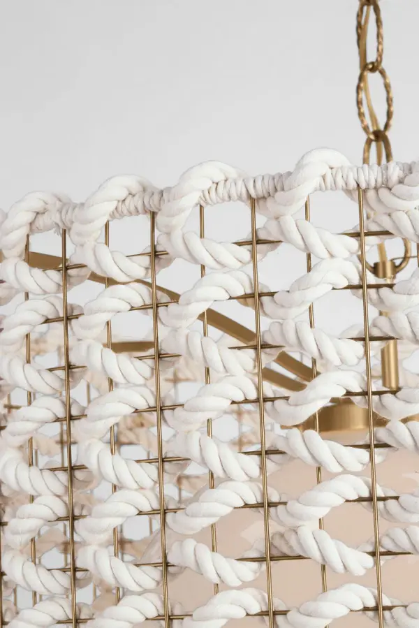 The Catania 30" pendant combines warm antique brass with handcrafted cream woven rope for a sophisticated coastal aesthetic. Its generous scale makes it perfect for anchoring dining rooms or large kitchen islands with organic texture. - alternate view