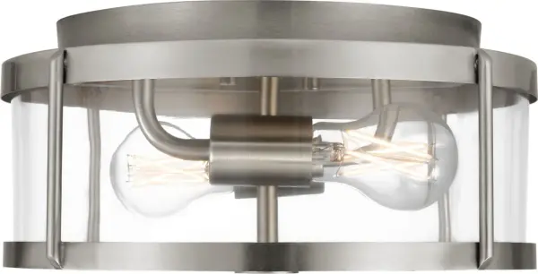 The Lumra 13" Flush Mount combines contemporary design with industrial transparency. Its structured metal frame and clear glass panels create an open, airy aesthetic while providing functional illumination for compact spaces.