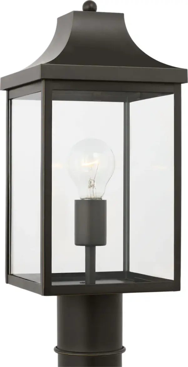 The Saybrook Medium Post Lantern combines traditional design with durable outdoor construction. Its antique bronze finish and clear glass panels create welcoming illumination for entryways and pathways.