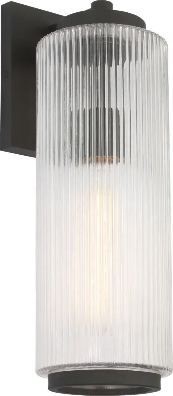 The Ronde Large Wall Lantern combines vertical ribbed glass with a sleek metal frame in Textured Black. Wet-rated for durability and available with Dark Sky accessories, it's ideal for patios, porches, and entryways.