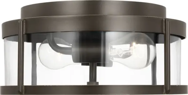 The Luning Medium Flush Mount combines a rounded metal frame with a cylindrical clear glass diffuser for a sleek, functional outdoor lighting solution. Wet-rated for all-weather durability and compact profile. - alternate view