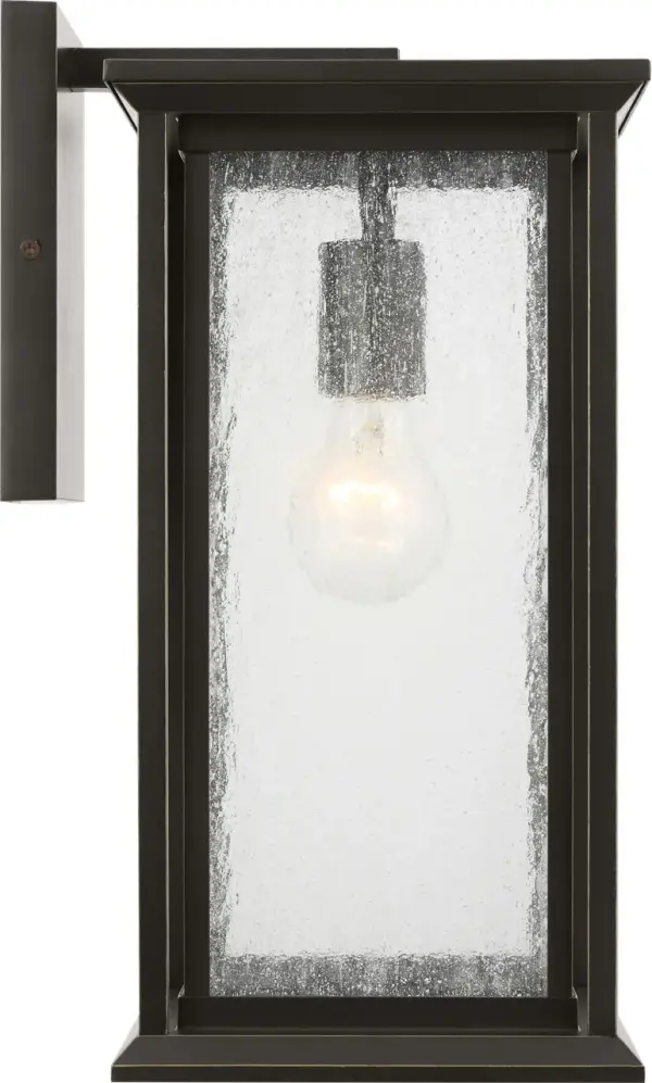 The Audley Medium Lantern combines traditional lantern styling with contemporary clean lines. Featuring distressed seeded glass panels and candle-style lamp sleeves in weather-resistant Antique Bronze finish, it's wet-rated for reliable outdoor performance.