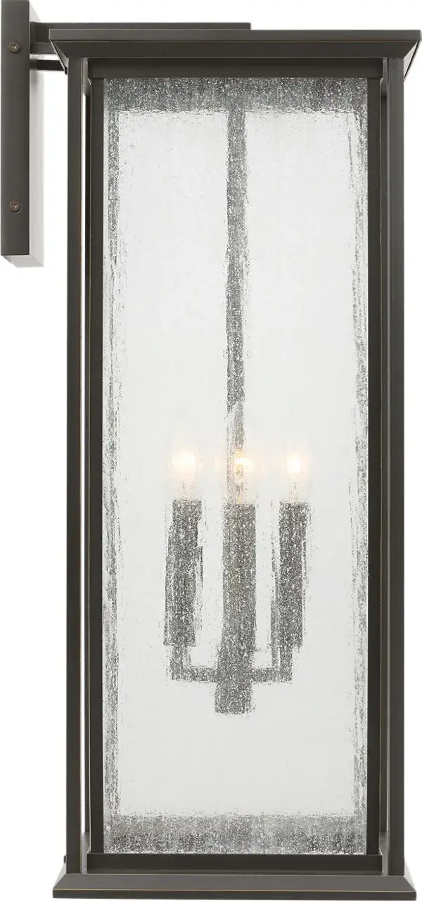The Audley Extra Large Lantern combines classic lantern proportions with contemporary clean lines, featuring distressed seeded glass and weather-resistant antique bronze finish. Wet-rated for durability and scaled for large facades.