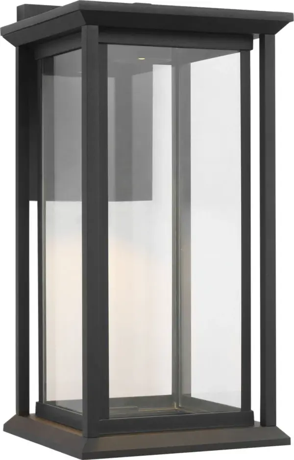 The Audley Medium Lantern delivers timeless outdoor elegance with integrated LED technology. Its rectangular metal frame and clear glass panels provide soft, diffused light while maintaining weather-resistant durability. - alternate view
