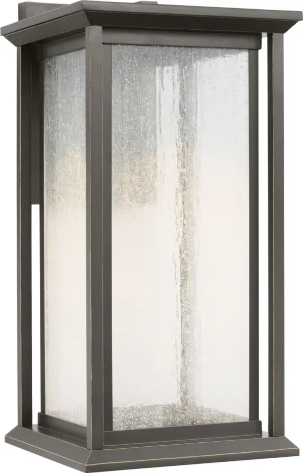 The Audley Medium Lantern blends traditional lantern styling with modern LED efficiency. Its distressed seeded glass creates soft, diffused light while the weather-resistant antique bronze finish ensures durability. Dark Sky Compliant and wet-rated for reliable outdoor performance.