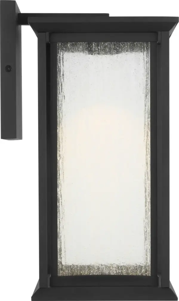 The Audley Medium Lantern blends timeless lantern styling with integrated LED technology. Its textured black finish and distressed seeded glass create warm, diffused light perfect for exterior spaces. Dark Sky Compliant and wet-rated for durability.