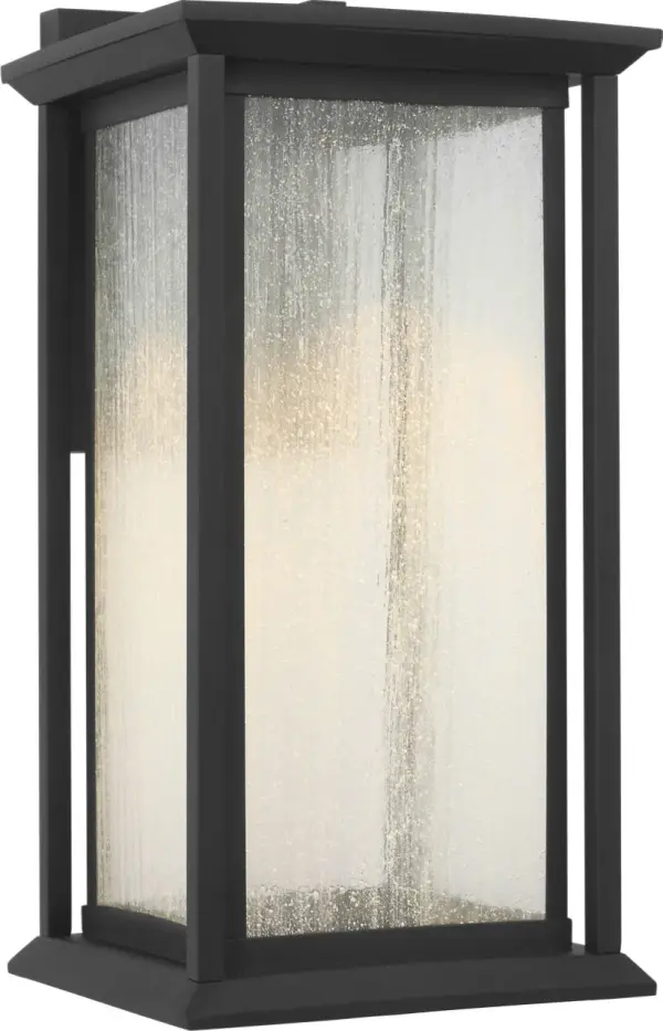 The Audley Medium Lantern blends timeless lantern styling with integrated LED technology. Its textured black finish and distressed seeded glass create warm, diffused light perfect for exterior spaces. Dark Sky Compliant and wet-rated for durability. - alternate view