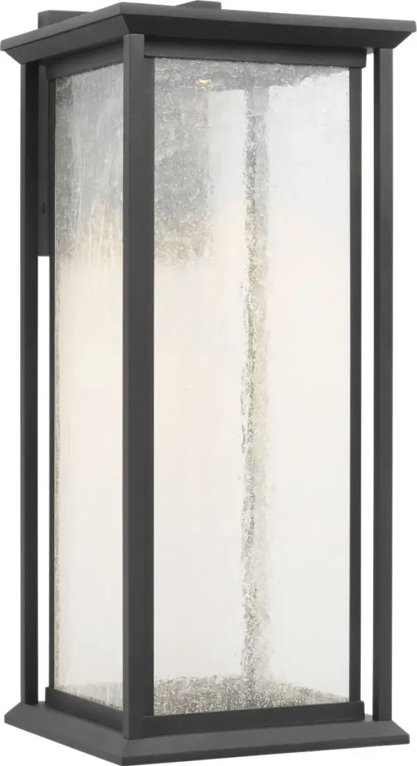 The Audley Large Lantern blends timeless lantern styling with integrated LED technology. Its distressed seeded glass panels create soft, diffused light while the textured black finish adds durability and visual appeal for outdoor spaces.