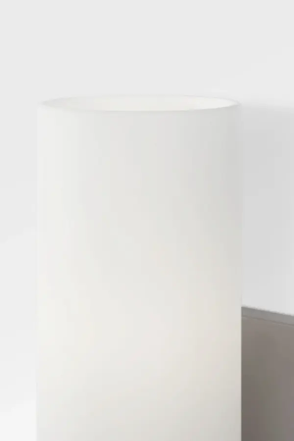 The Neblina vanity light merges contemporary design with practical functionality. Its frosted domed shade provides soft, diffused illumination while the brushed nickel finish and clean architectural lines adapt seamlessly to modern bathrooms and powder rooms. - alternate view