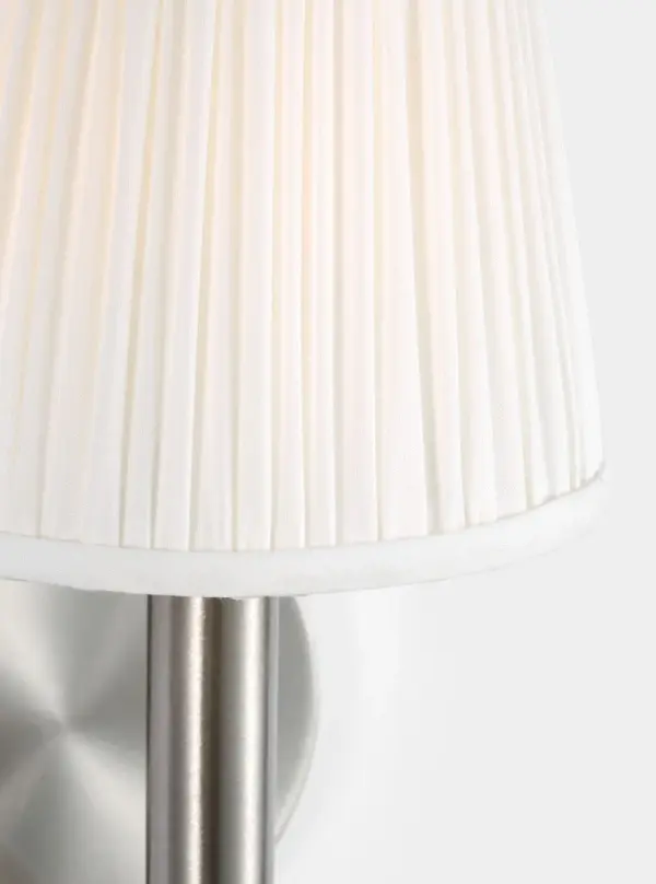 The Vilera sconce brings refined elegance with its gathered white fabric shade and brushed nickel finish. Perfect for hallways and bedrooms, it delivers soft, diffused lighting ideal for creating welcoming ambiance. - alternate view