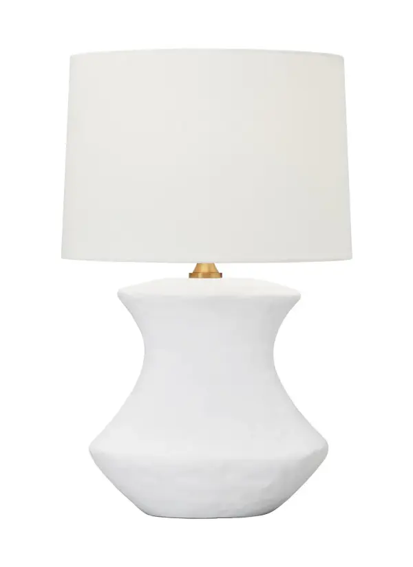 The Bone table lamp by Hable features a hand-crafted ceramic base with unique sculptural form and matte white finish. Its crisp white linen shade and brass hardware create an understated elegance that bridges traditional and contemporary styles.