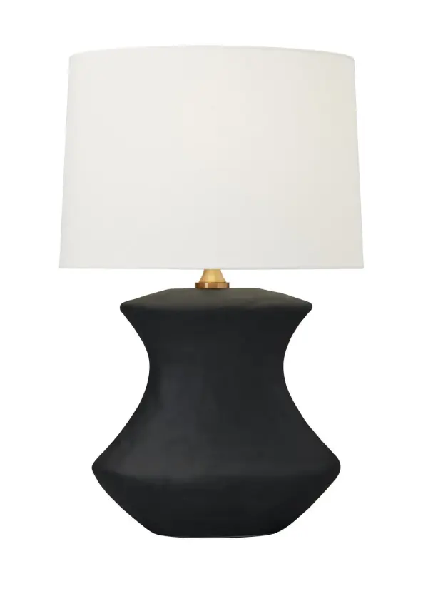 The Bone table lamp by Hable combines artisanal ceramic craftsmanship with contemporary design. Its unique sculptural base in rough black ceramic creates visual interest while the crisp white linen shade and brass hardware add refined contrast.
