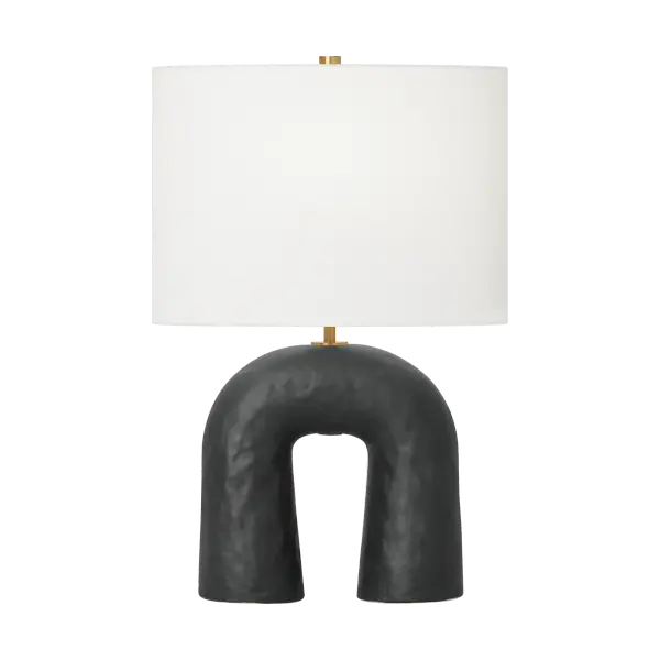The Aura Small Table Lamp combines artisanal craftsmanship with contemporary design. Its hand-sculpted ceramic base features organic curves and tactile texture, complemented by brass accents and a white linen shade for soft, ambient lighting.