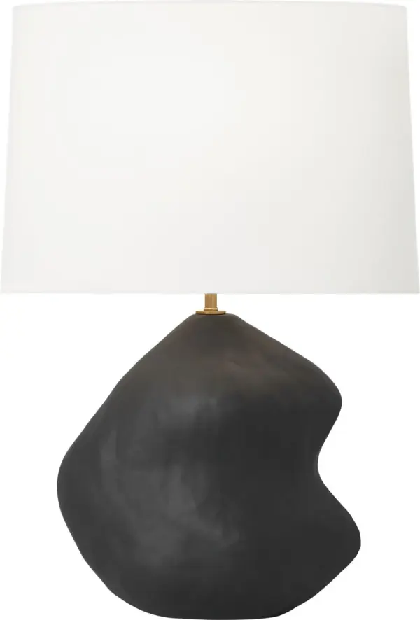 The Broxton Medium Table Lamp by Hable combines organic ceramic artistry with refined brass accents. Its fluid, curving silhouette creates a striking focal point while the white linen shade provides soft, ambient lighting.