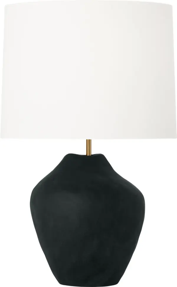 The Cadley Medium Table Lamp by HABLE showcases hand-sculpted ceramic artistry with a rough black finish that adds textural depth and visual interest. Its organic form creates an instant focal point while the classic white linen drum shade provides warm, inviting illumination perfect for contemporary interiors. - alternate view