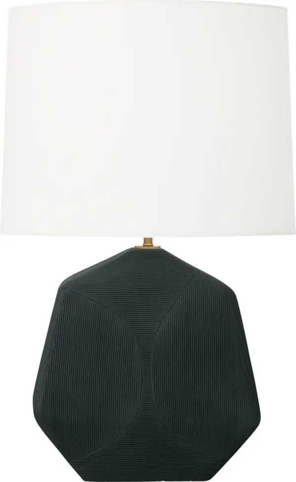 The Tallulah Medium Table Lamp features a striking sculptural ceramic body with delicate geometric etching that adds artisanal character. The rough black ceramic finish paired with a white linen drum shade creates sophisticated contrast while diffusing warm, ambient light. - alternate view