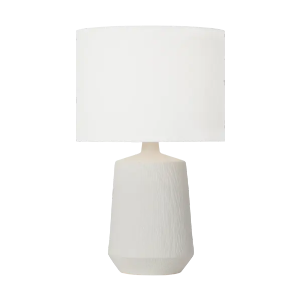 The Panola Medium Table Lamp combines handcrafted artistry with contemporary design. Its matte white ceramic base features vertical etchings that create visual texture, while brass detailing adds warmth. The white linen drum shade provides soft, diffused lighting perfect for ambient illumination.