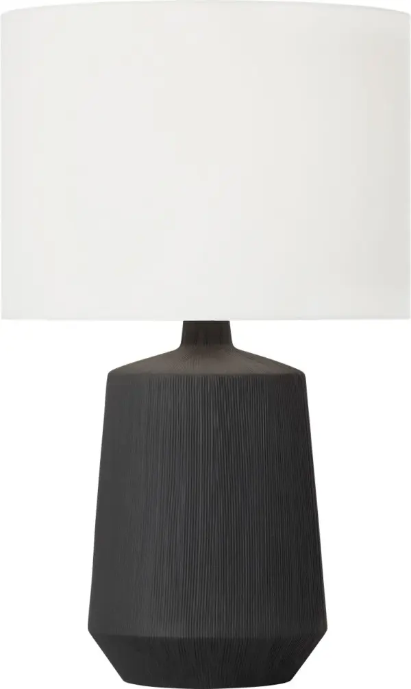 The Panola Medium Table Lamp combines handcrafted ceramic artistry with contemporary minimalism. Its vertical etchings create tactile interest while the white linen shade softly diffuses light. Brass accents add warmth to the matte black finish. - alternate view