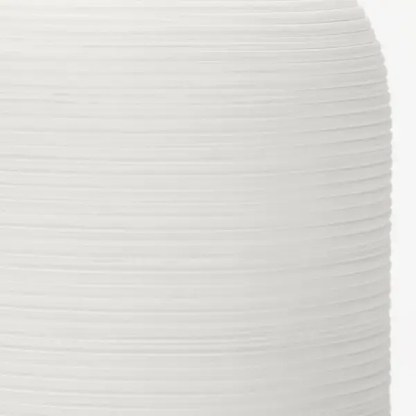 The Fanny Small Table Lamp features a refined matte white ceramic base that brings understated elegance to any space. Its compact size makes it perfect for nightstands and smaller surfaces while delivering quality lighting. - alternate view